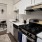 a kitchen with a white tile backsplash