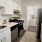 a kitchen with a white tile backsplash